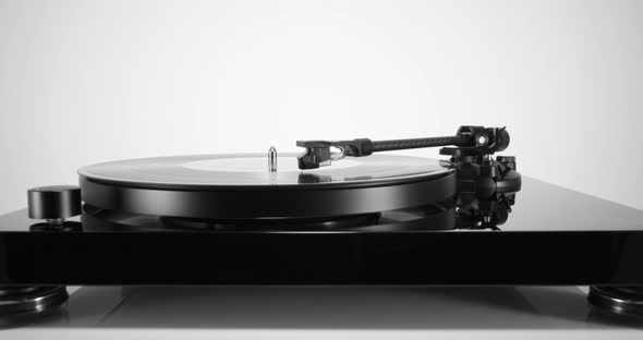 Turntable with Spinning Vinyl Record on White Table