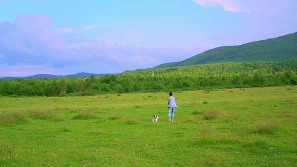 Female with Dog Playing Outdoors