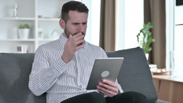 Young Businessman Reacting To Failure on Tablet at Home 