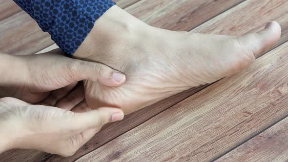 Woman Touching Foot In Pain Close Up.