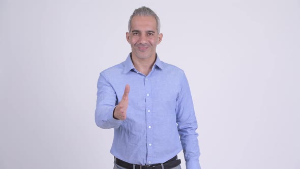 Happy Persian Businessman Giving Handshake Against White Background
