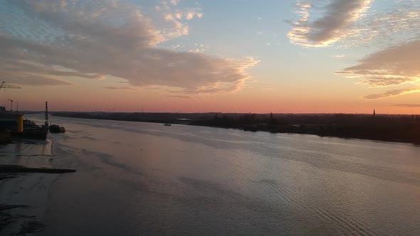 Golden sunset and industrial part of Antwerp harbor, aerial drone view