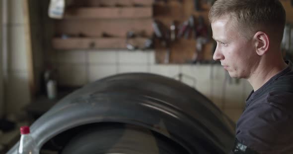 Mechanic Controls a Balance Process of Tire on Wheel in Auto Service