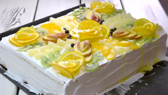 Cook Pouring Jelly on Decorated Cake