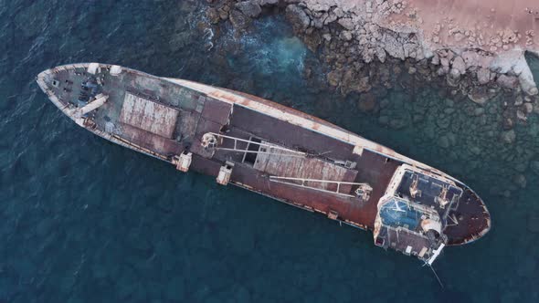 Aerial Of Rusty Shipwreck Close To Shore With Crashing Waves During Sunset 13
