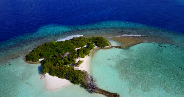 Tropical above tourism shot of a sunshine white sandy paradise beach and aqua turquoise water backgr