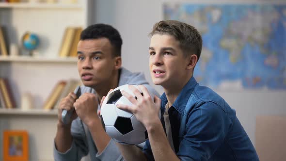 Multiracial Male Friends Cheering for Football Team, Happy With Successful Match