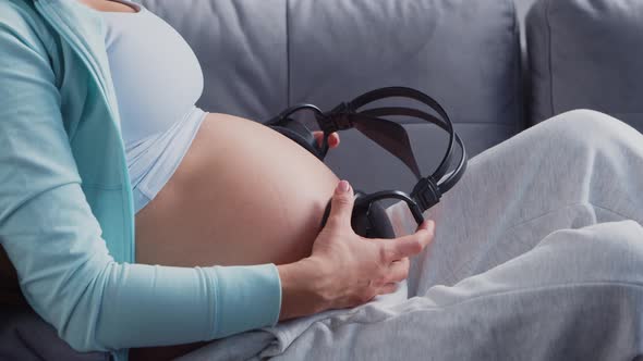 Young pregnant woman is resting at home and expecting a baby.