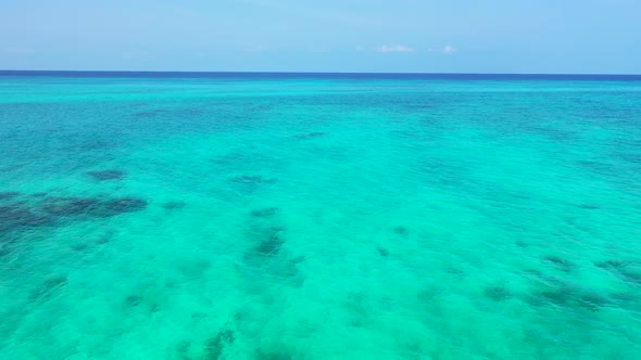 Luxury above tourism shot of a white paradise beach and aqua blue water background in colourful 4K