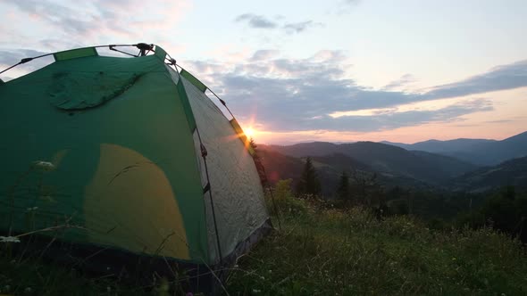 Beautiful Sunset on the Mountains of the Swiss Alps View with a Tent