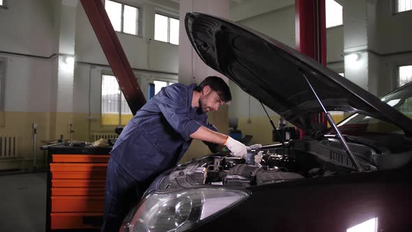 Repairman Using Wrench While Replacing Oil Filter