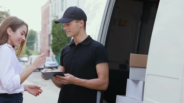 Delivery Courier Service. Man Delivering Package To Woman