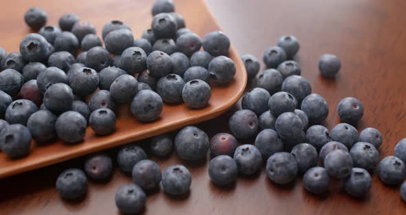 blueberry on wooden plate