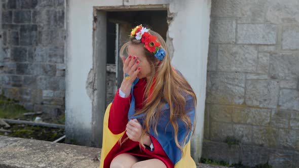 Ukrainian Girl Cries Near the Destroyed House Flag of Ukraine