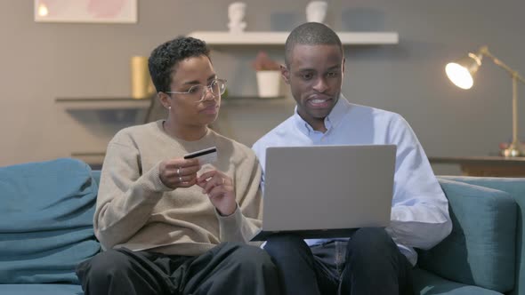 Couple Having Online Shopping Failure on Laptop on Sofa