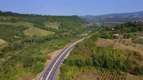 Drone Aerial Flight Over the Road with Green Surroundings on the Side