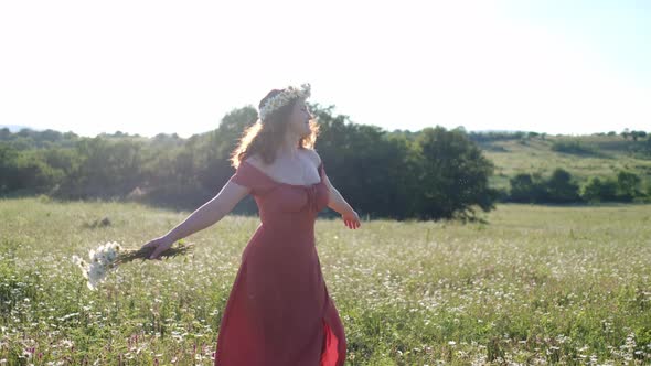 Beautiful Young Woman in Chamomile Field