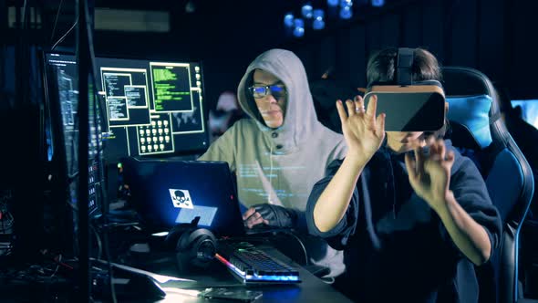 Cyber Crime and Hacking Concept. Woman Wearing VR Glasses While Hacking Computer, Close Up.