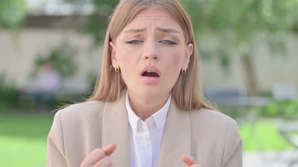 Outdoor Portrait of Young Businesswoman Reacting to Loss