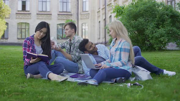 Best Friends Spending Time Together Sitting on Grass in University Garden