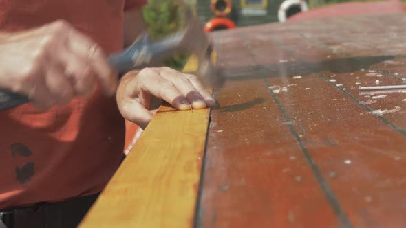 Securing timber plank with pins