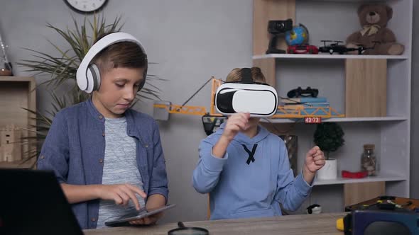 Teen Brothers which Playing Video Games Using Virtual Reality Goggles