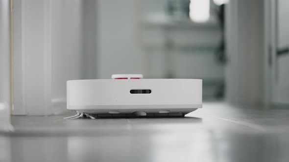 Robot Vacuum Cleaner Cleans a Modern Apartment