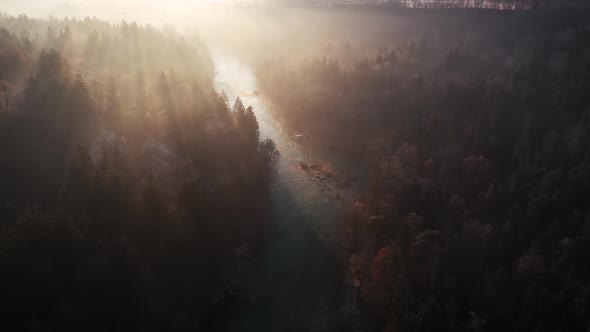 Flying over the river and hills at sunrise