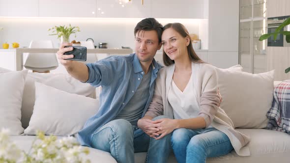 Cheerful Couple Looking at the Smartphone Screen