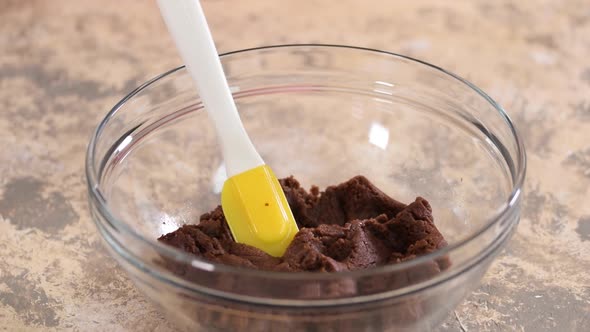 Preparing Chocolate Choux Dough in Bowl, Adding Eggs To the Dough