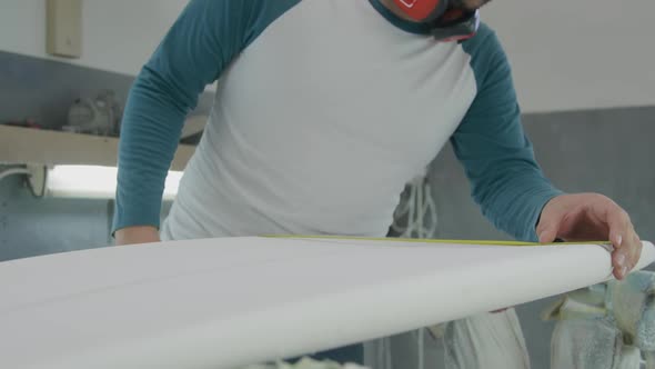Male surfboard maker in his workshop