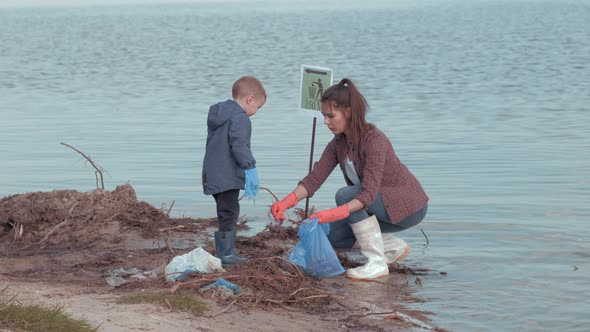 Family Cleaning Beaches, Young Female Volunteers with Kid Boy Clean Polluted Nature From Plastic