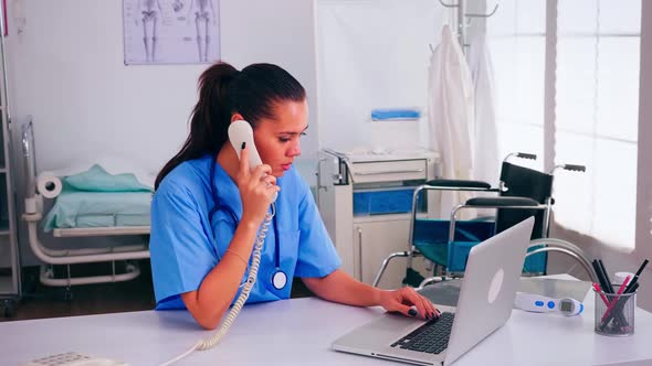 Medical Receptionist Speaking with Patient on Phone