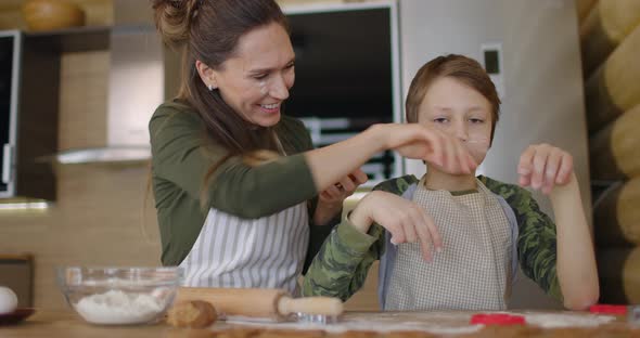 Young Family Mother and Son Making Homemade Cookies at Kitchen