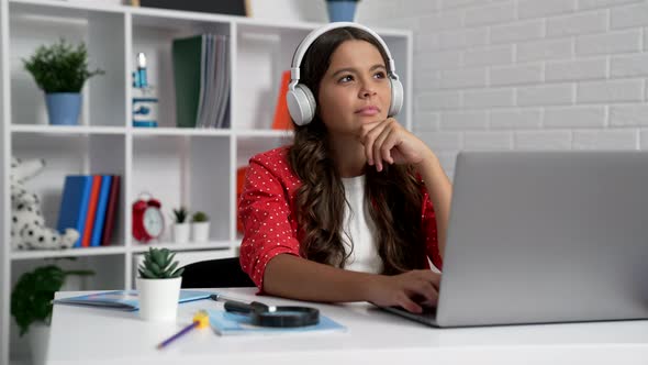 Cheerful Teen Girl in Headset Typing Online on Computer Education