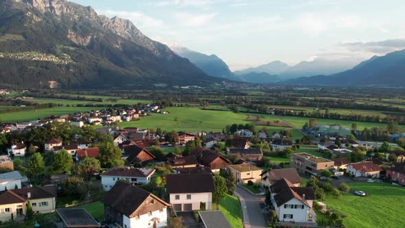 Aerial View of Liechtenstein with Houses on Green Fields in Alps Mountain Valley