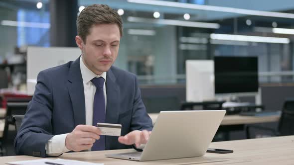 Businessman Making Online Payment Failure on Laptop in Office