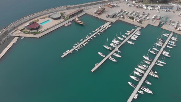 Docked recreational boats and yachts in marina, aerial view