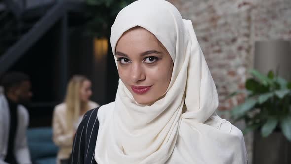 Attractive Muslim Woman in White Hijab Headscarf Looking at Camera