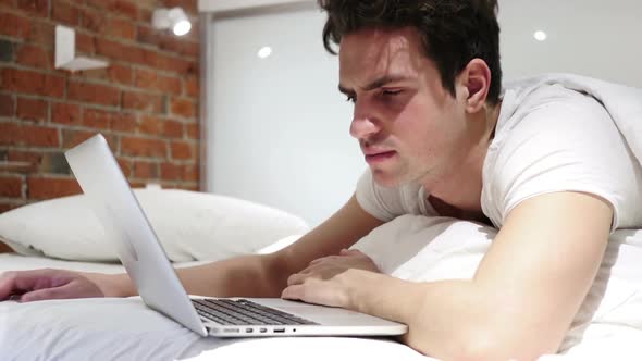 Man Awaking From Sleep and Starts Working on Laptop