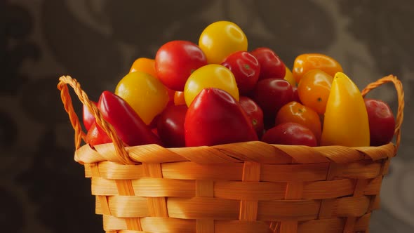 Farmer wicker basket with delicious tomatoes and peppers