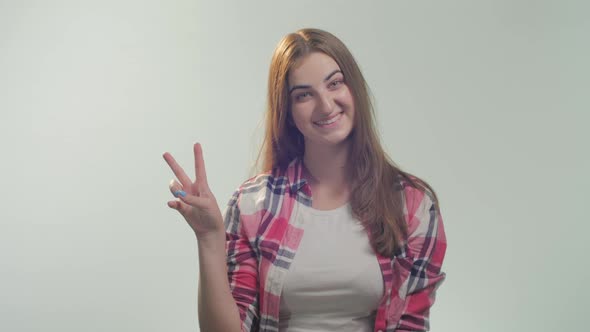 Young woman showing peace sign