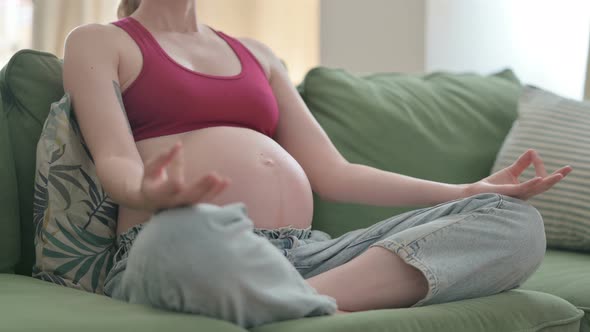 Close Up of Meditating Pregnant Woman Doing Yoga at Home