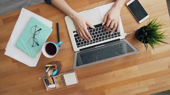 Female Hands Typing Using Laptop Computer in Office Communicating at Work