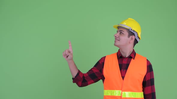 Happy Young Multi Ethnic Man Construction Worker Pointing Up