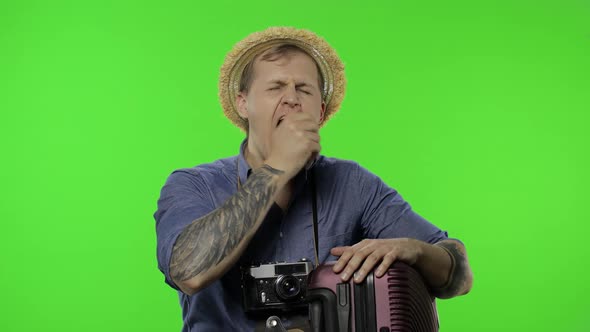 Portrait of Exhausted Man Tourist Photographer Shows Dissatisfaction. Chroma Key