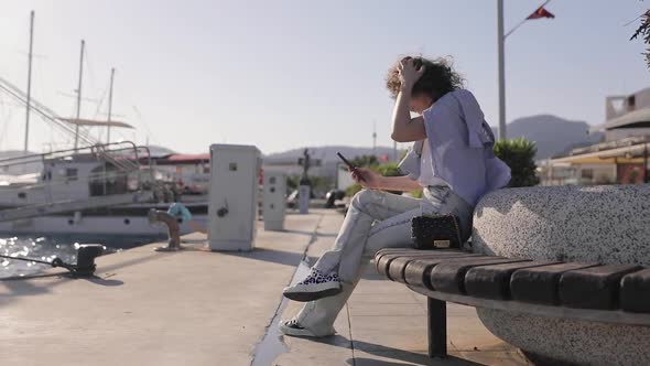 Young female traveling in Turkey, click on mobile phone, looking through information on smartphone.