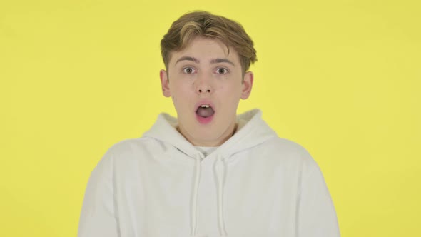 Shocked Young Man on Yellow Background