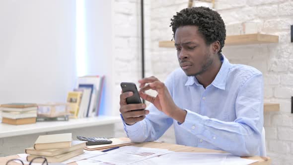 Stressed African Man Using His Cellphone