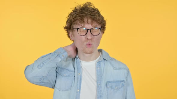 Tired Redhead Young Man with Neck Pain, Yellow Background